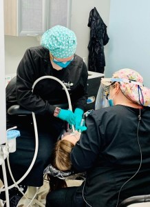 Team performing a dental filling procedure