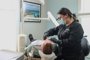 Staff performing teeth cleaning